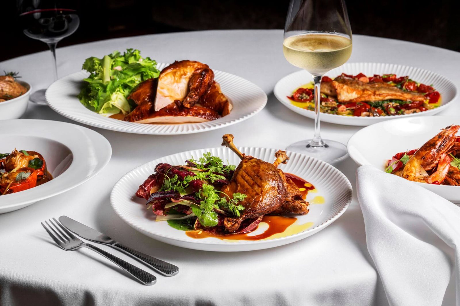 Ananas dining table with French brasserie dishes and wine